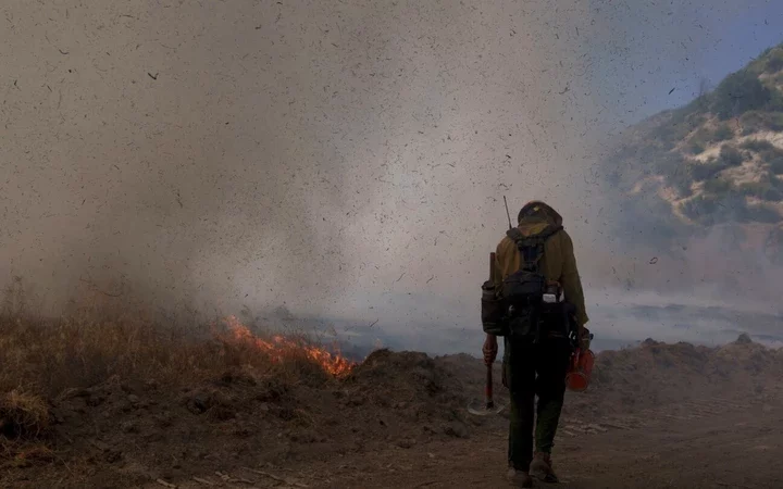 Battling the Blaze: Crews Brave Sweltering Heat and Steep Terrain in Los Angeles Wildfire Fight